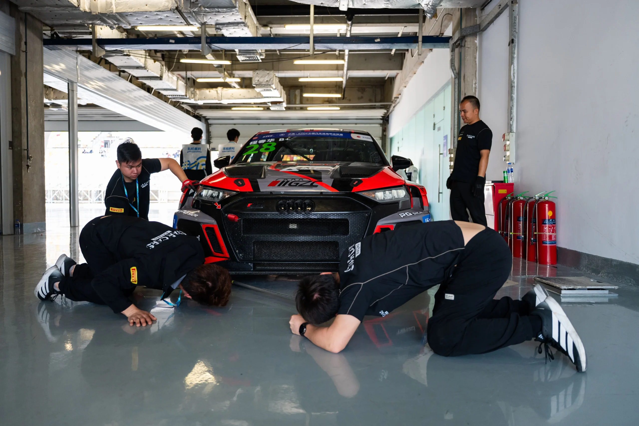 Complete TERZO race car and engineering crew during pit preparation